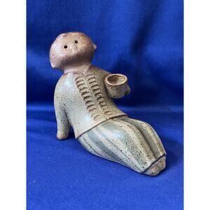 Stoneware Child Figurine Leaning Back and Holding Cup UCTCI
